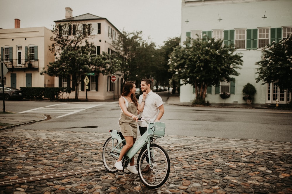 woman in white long sleeve shirt riding on bicycle during daytime