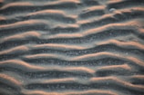 brown sand with water during daytime