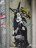 A series of black and white photographs capturing rabbit-themed street art.