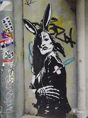 A series of black and white photographs capturing rabbit-themed street art.