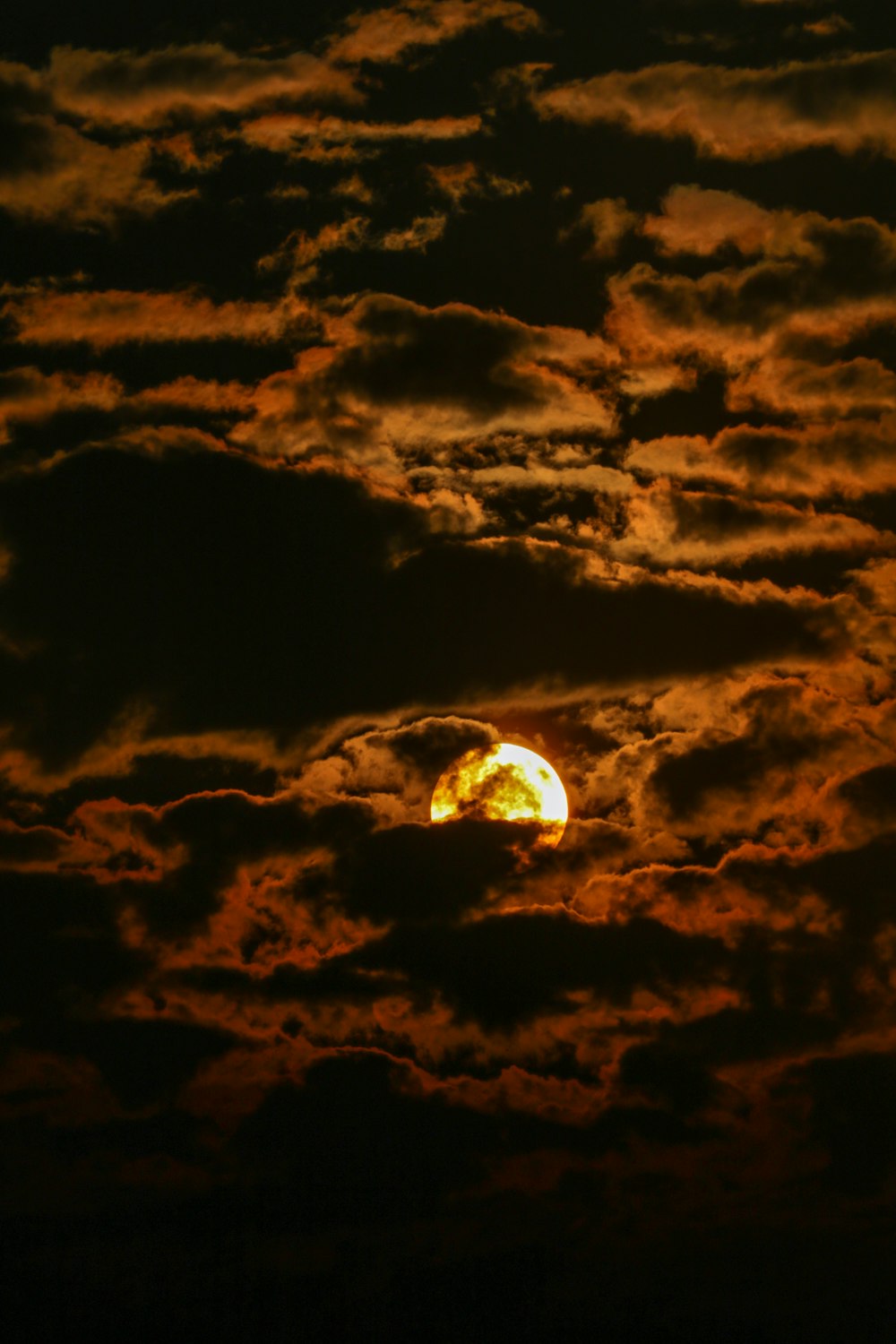 full moon covered by clouds