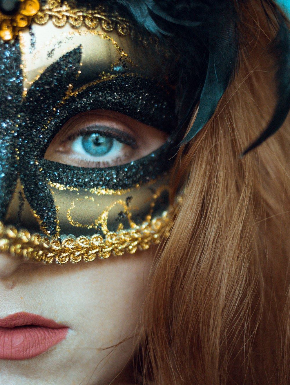 woman with gold and black face mask