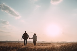 A serene couple holding hands during a sunset walk, symbolizing commitment and hope.