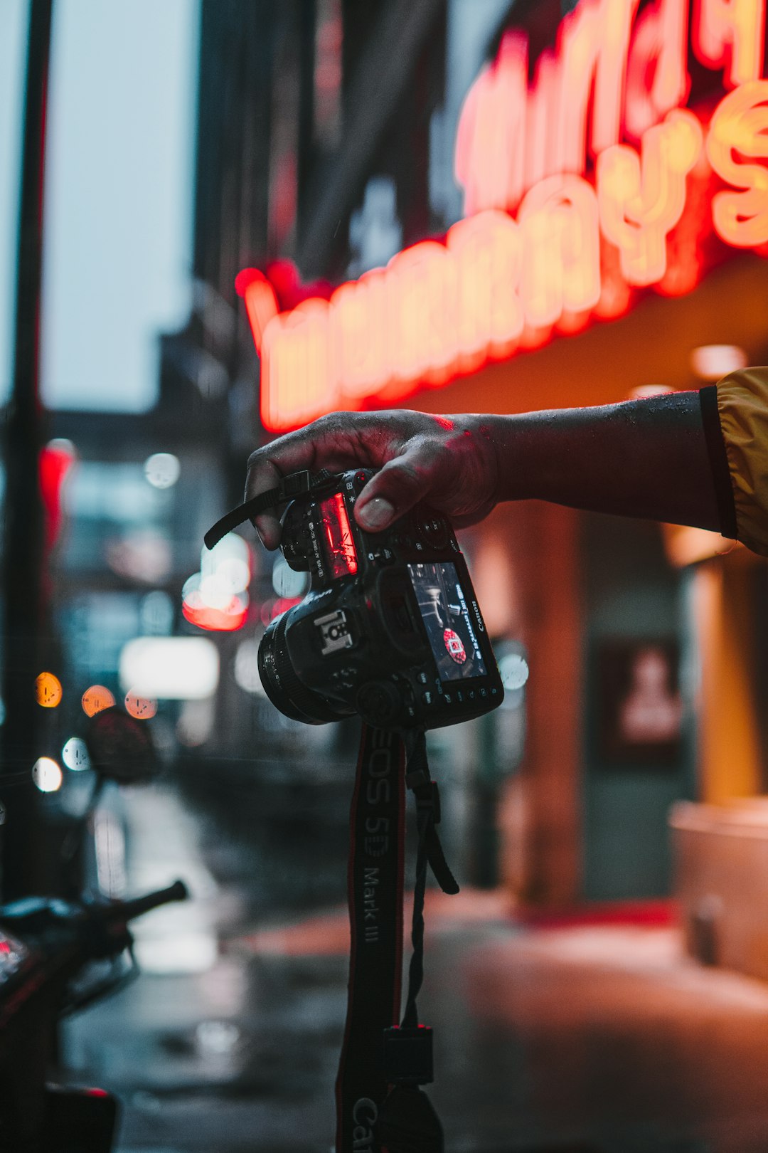 person holding black dslr camera