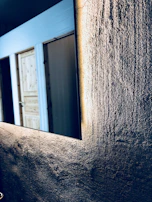 Glossy dark melamine door reflecting soft indoor lighting.