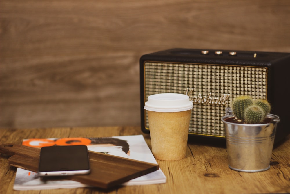 white and brown coffee cup on brown wooden table