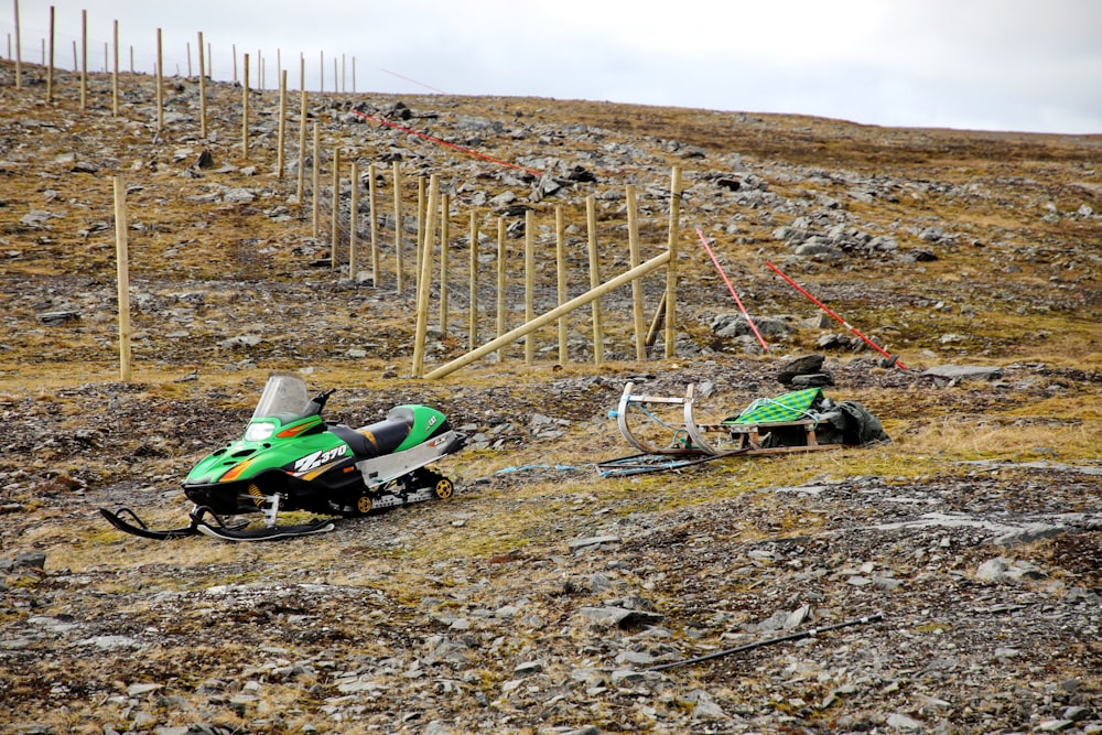 green and black helicopter on brown field during daytime