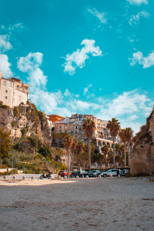 cars parked on parking lot near buildings during daytime in Tropea Italy