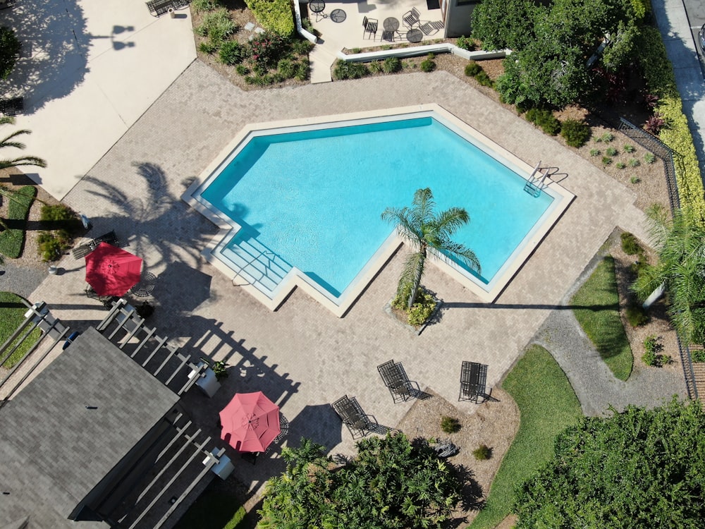 swimming pool with red and black chairs