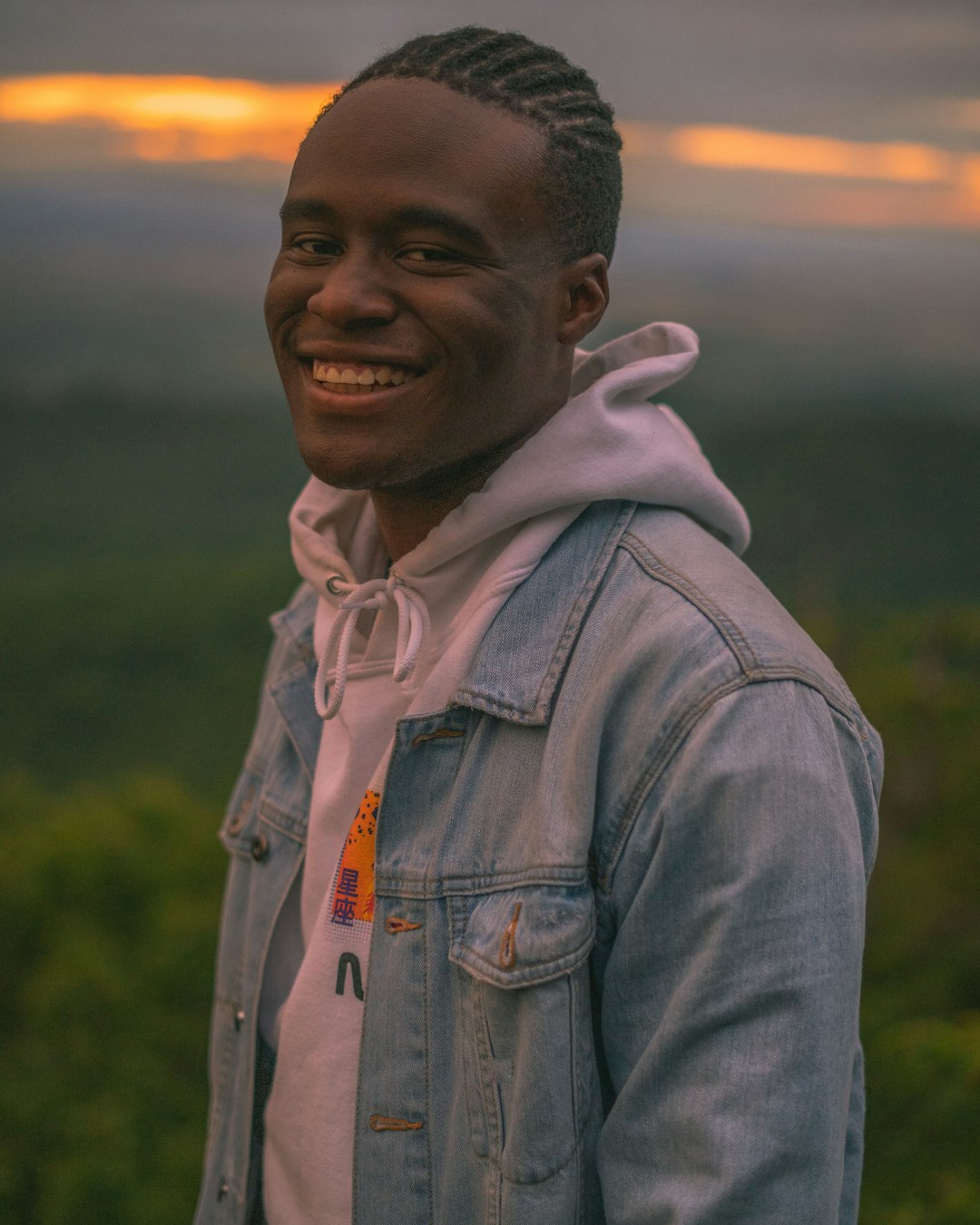 smiling man in gray denim jacket