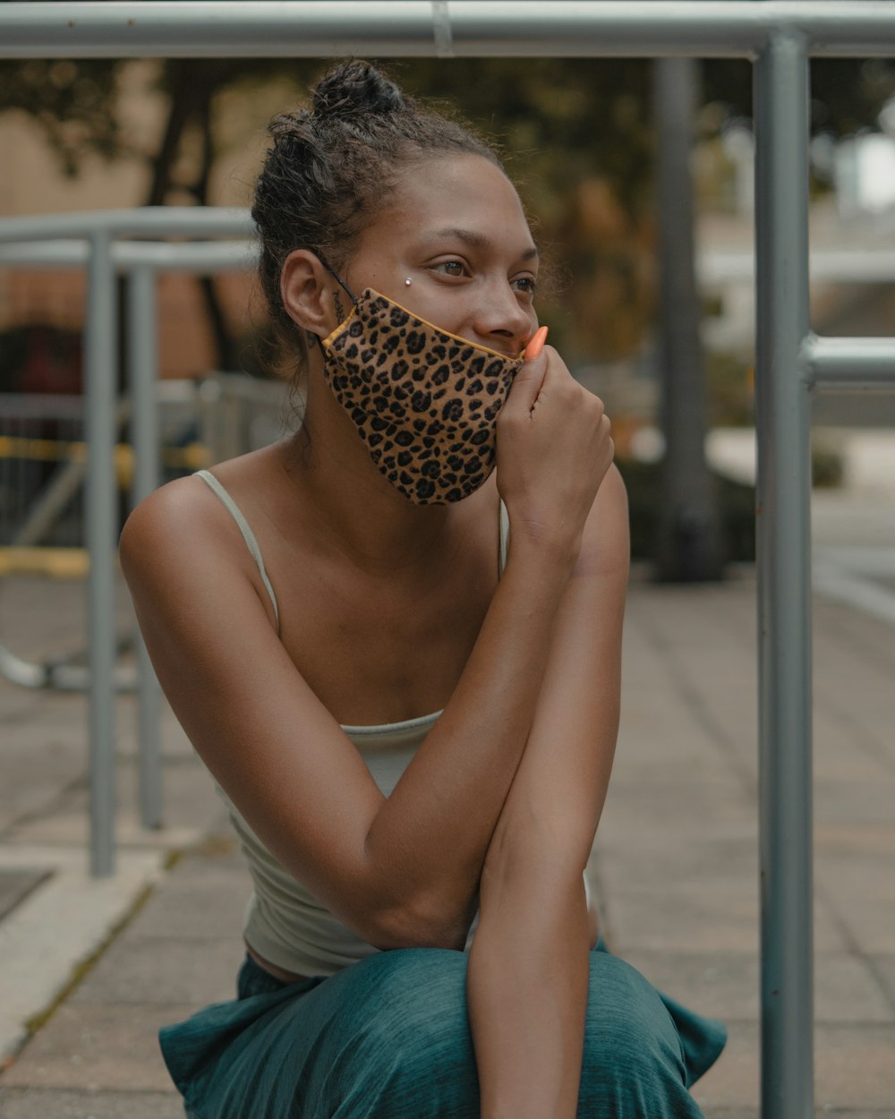 woman in blue tank top holding brown and black leopard print textile