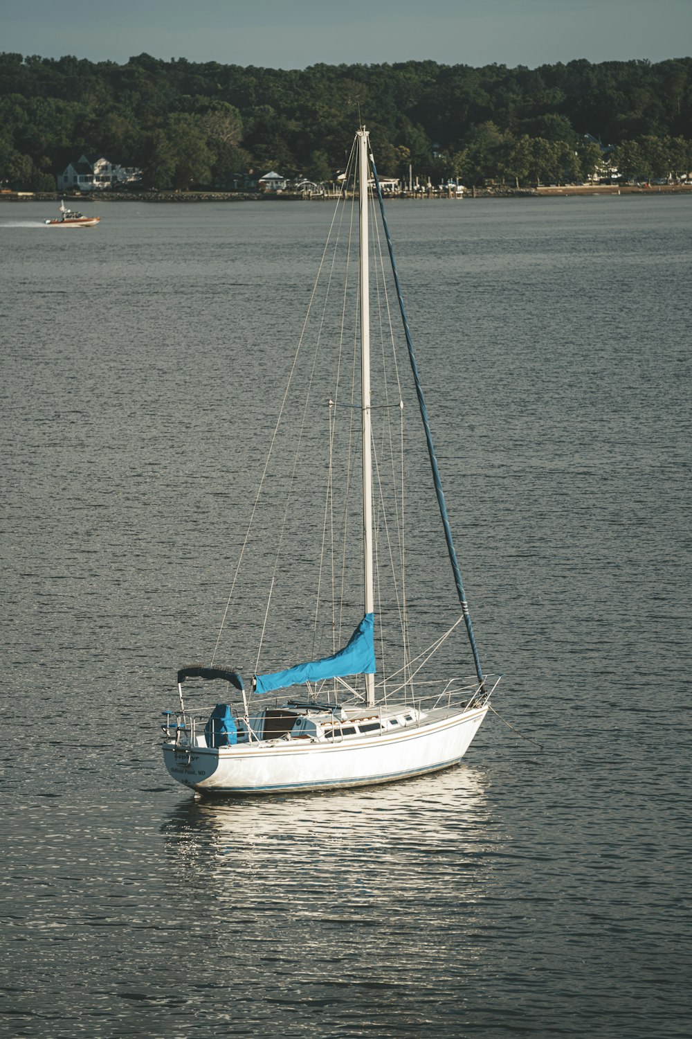 white and blue sailboat on sea during daytime