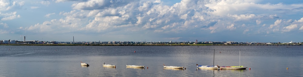 white boat on body of water during daytime