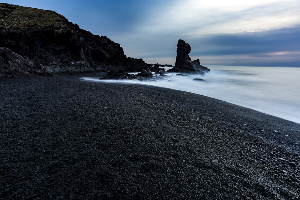 brown rock formation on sea shore during daytime