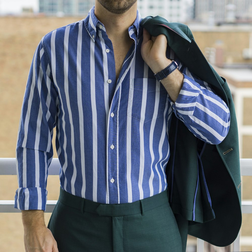 man in blue and white striped dress shirt and black dress pants photo –  Free Chicago Image on Unsplash