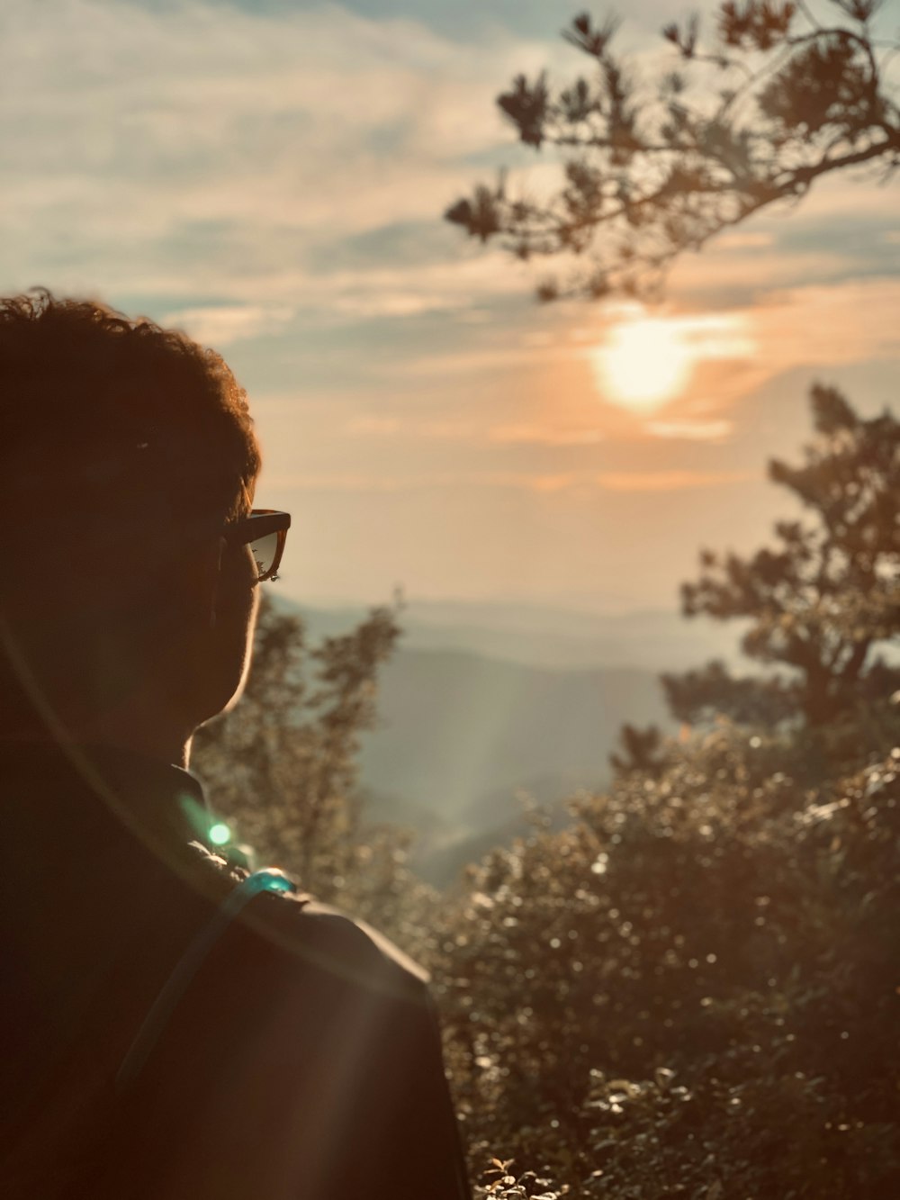 man in black framed sunglasses and green shirt