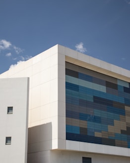 white and blue concrete building under blue sky during daytime