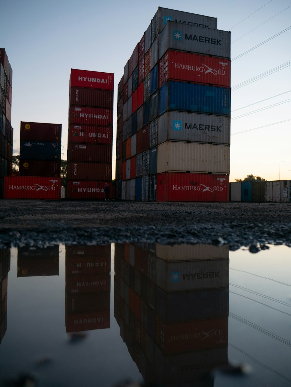 red and blue cargo containers on brown wooden dock during daytime