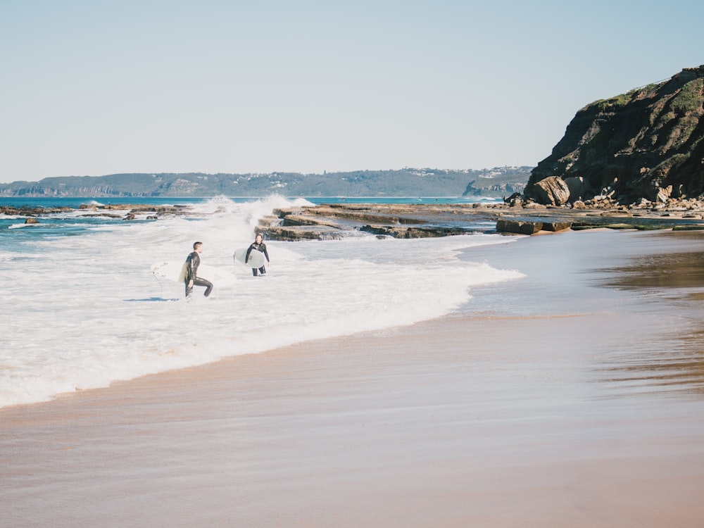 people walking on beach during daytime