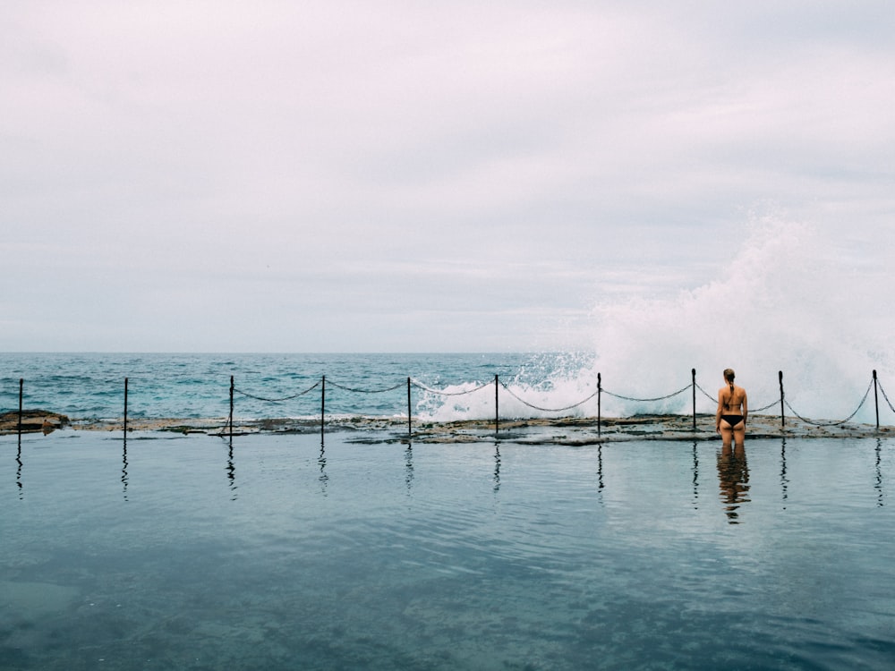 2 people standing on sea dock during daytime