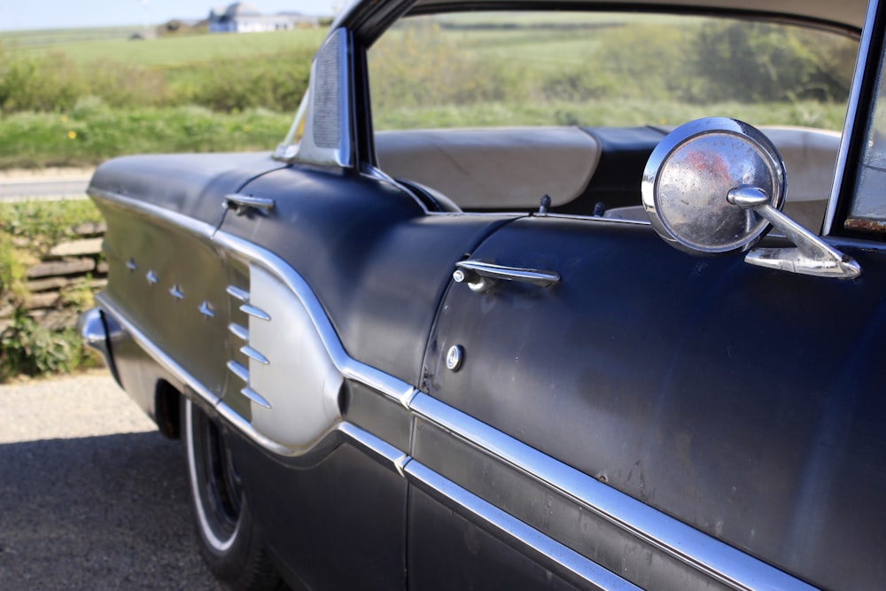 blue classic car on road during daytime