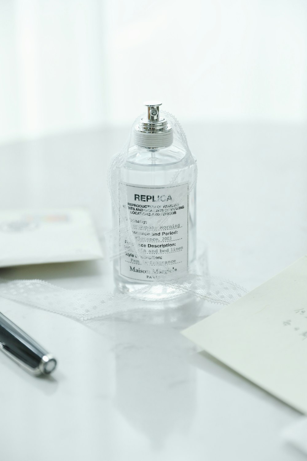 clear glass bottle on white table