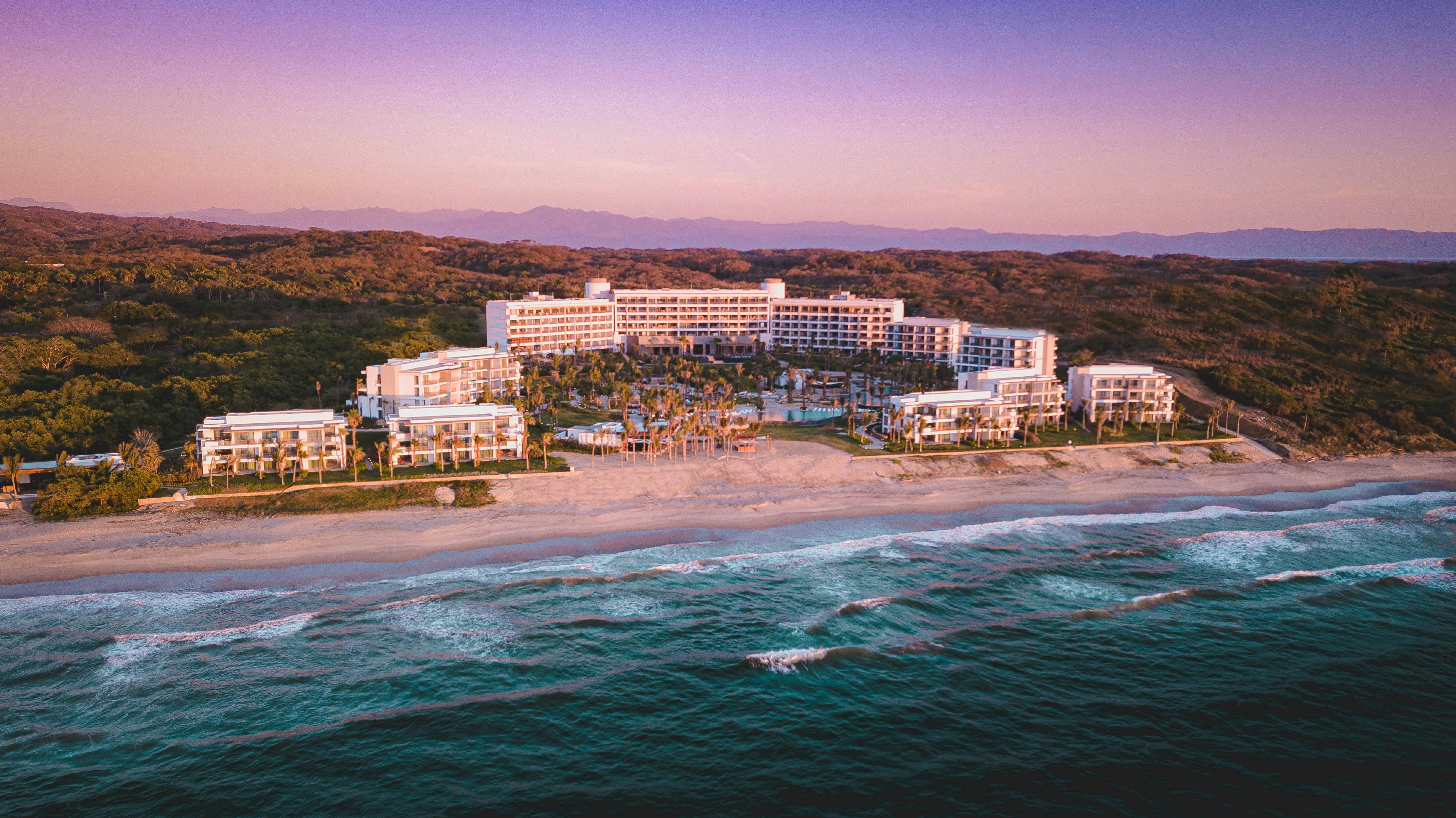 aerial view of city buildings near body of water during daytime, Hotel Conrad Punta de Mita. 