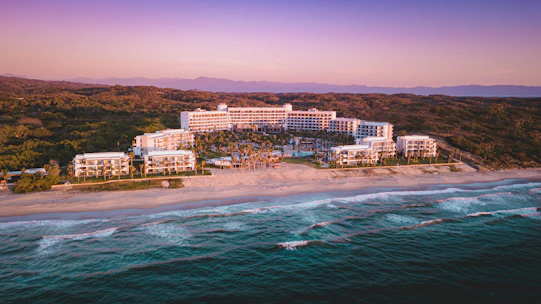 aerial view of city buildings near body of water during daytime