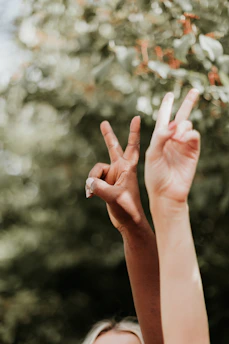 persons hand with white manicure