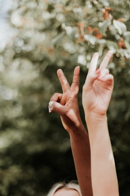 persons hand with white manicure