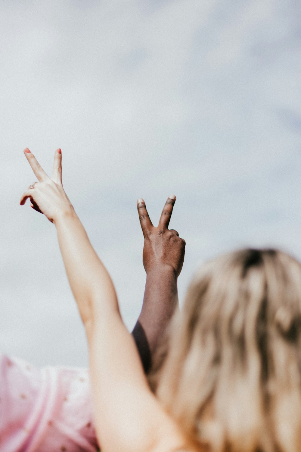 2 person doing heart hand gesture