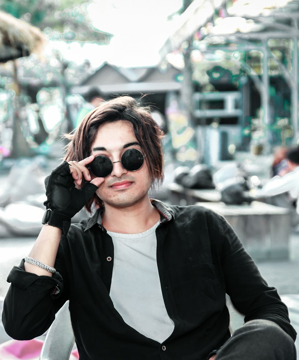 woman in black leather jacket wearing black sunglasses
