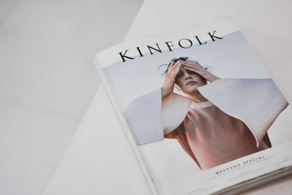 a magazine with a picture of a woman covering her eyes
