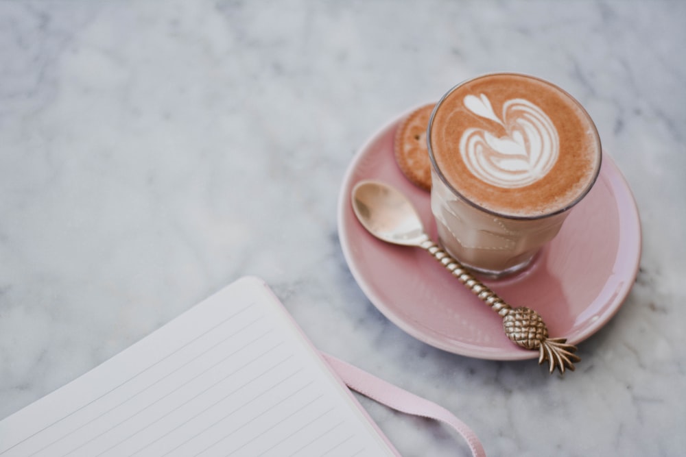 white ceramic cup with saucer on white table