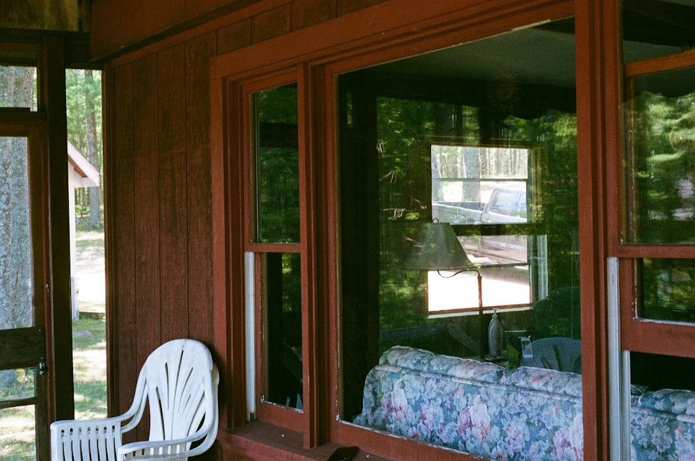 white plastic chair beside brown wooden cabinet