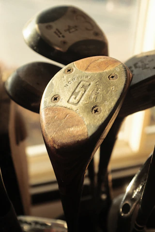 Close-up of a handcrafted wooden Indian club, showcasing its rich texture and history.