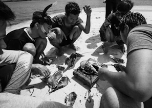 Guests enjoying a cooking class on the beach with a local chef