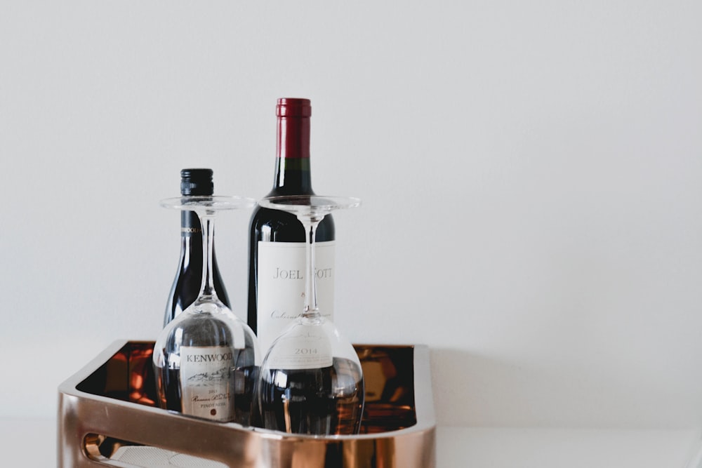 black glass bottle on brown wooden table