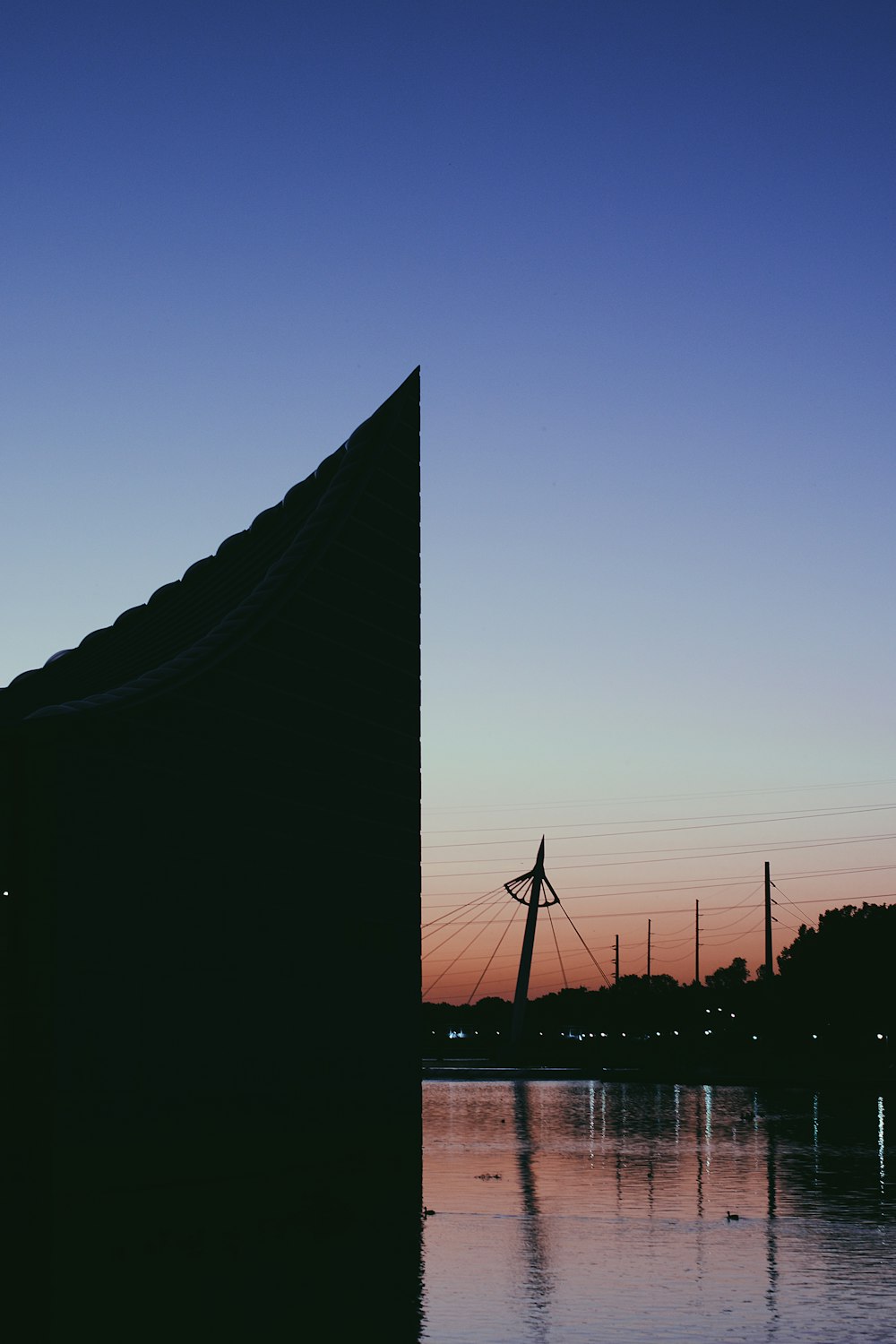 a body of water with power lines in the background