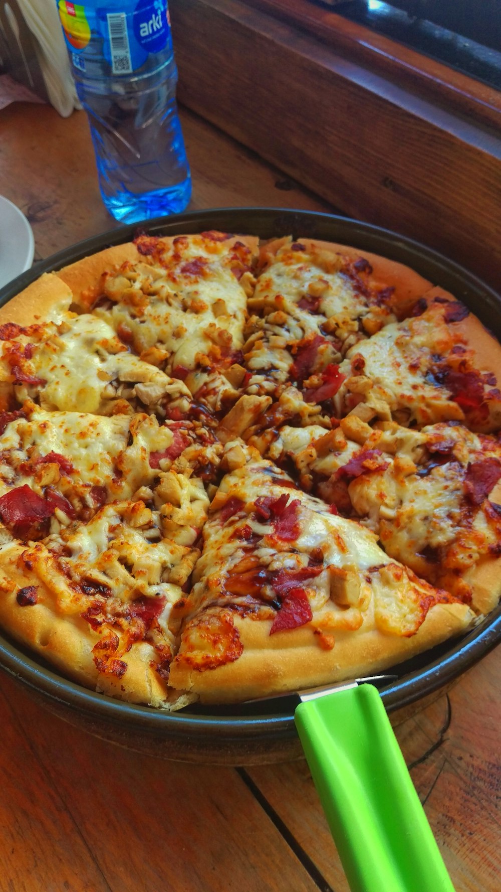 pizza on brown wooden round plate