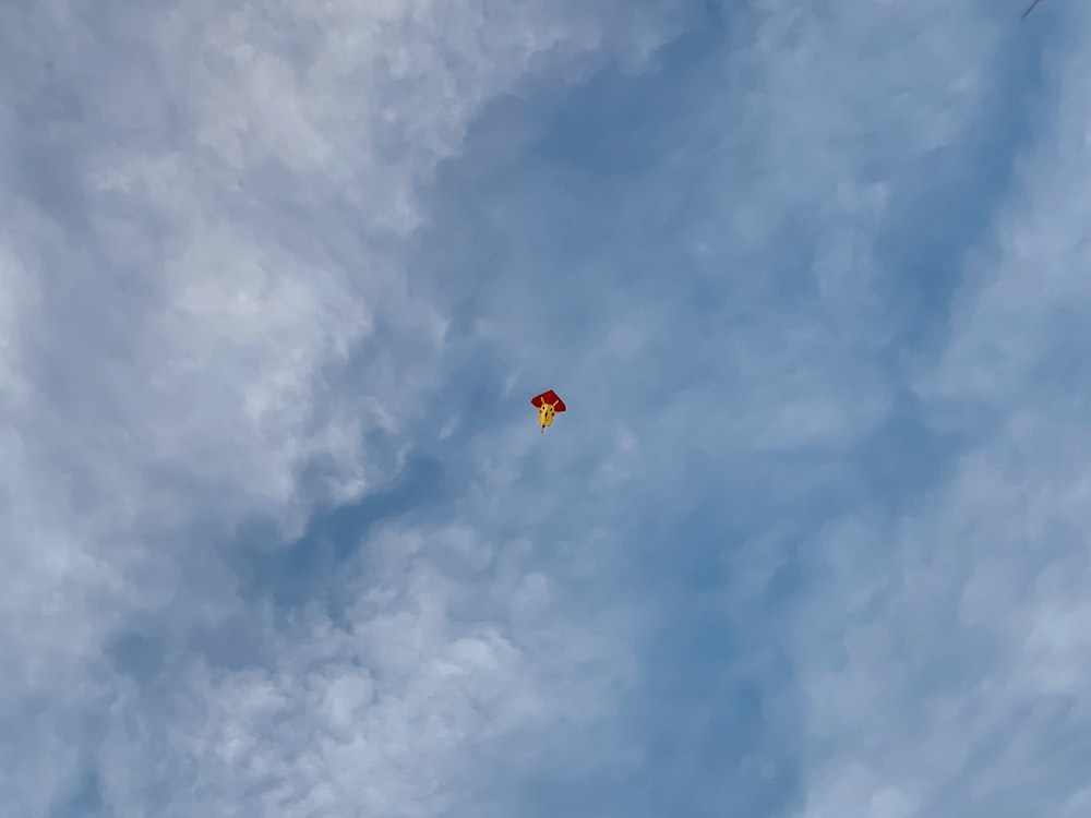 orange and yellow parachute in the sky
