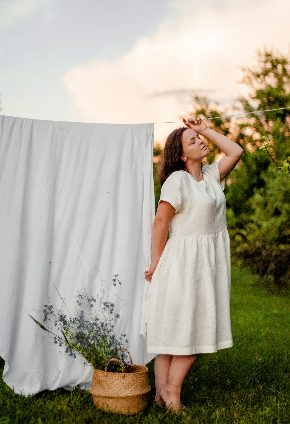 woman in white dress standing on green grass field