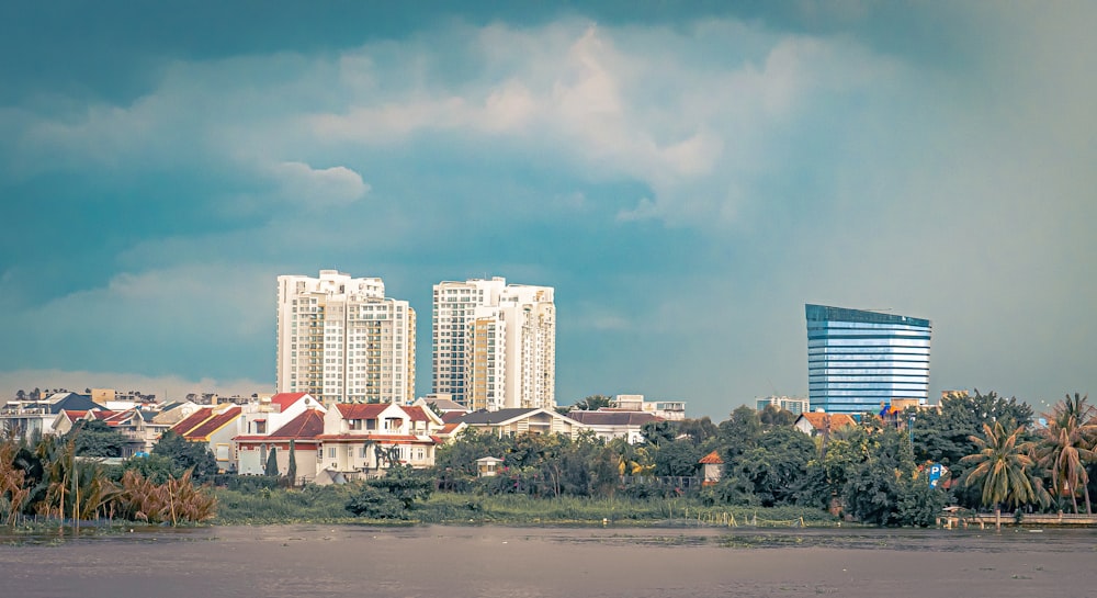 city buildings near green trees under blue sky during daytime