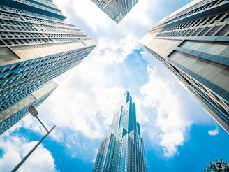 low angle photography of high rise buildings under blue sky during daytime