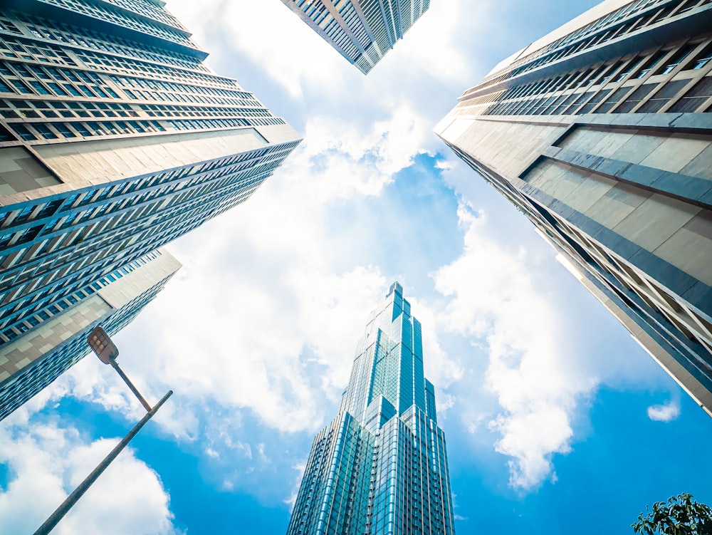 low angle photography of high rise buildings under blue sky during daytime