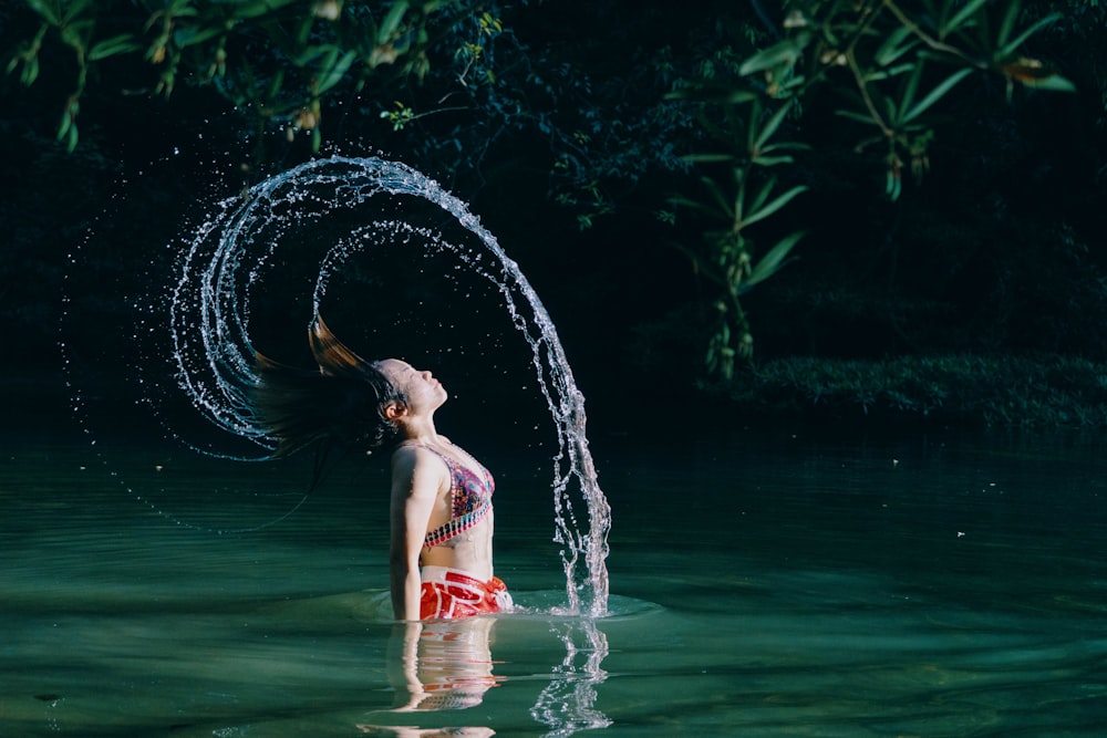 woman in blue bikini on water