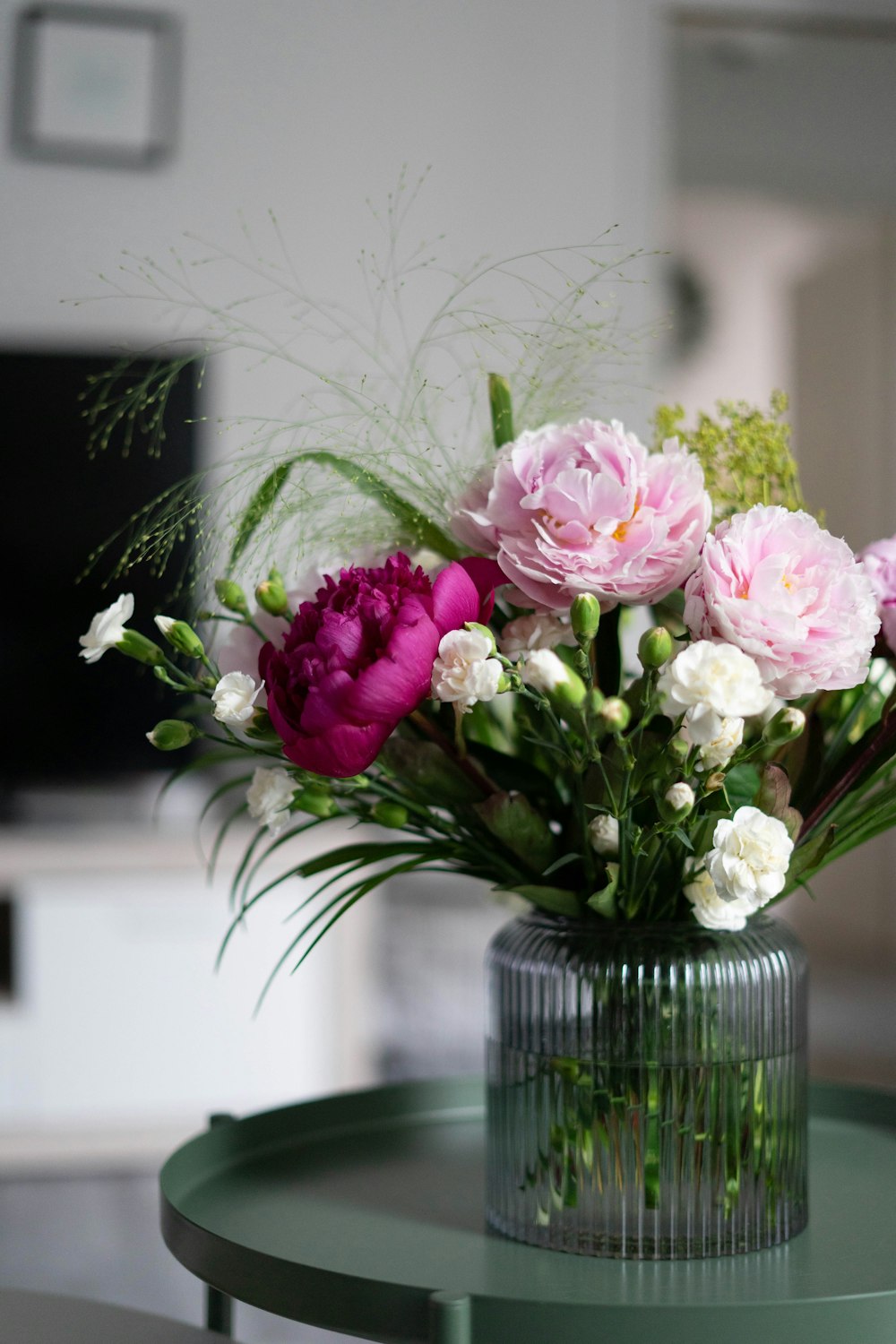 pink and white flowers in clear glass vase