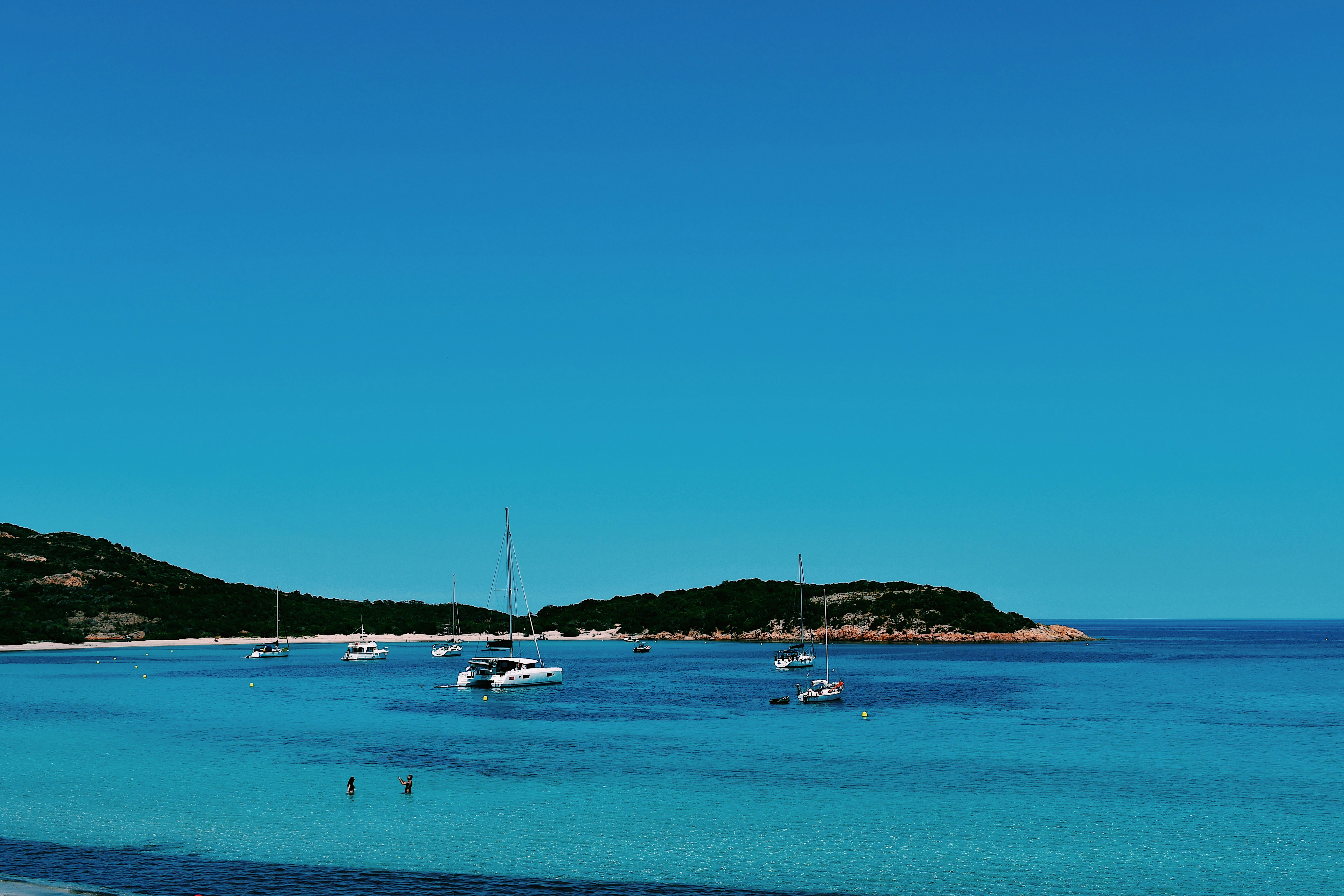 white boats on sea during daytime