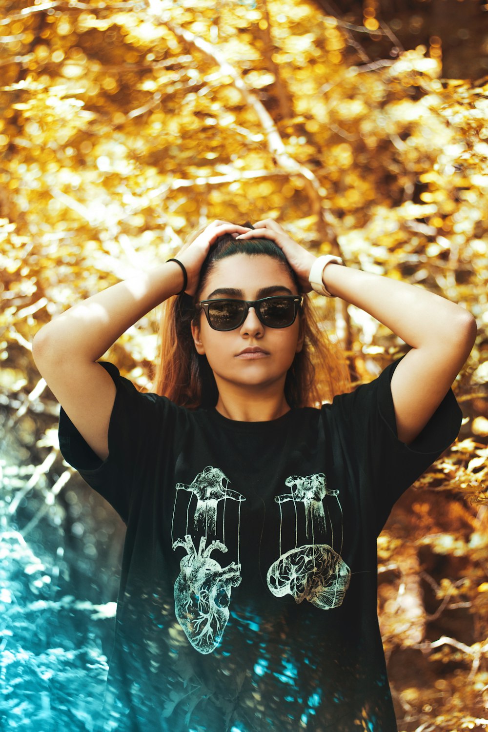 woman in black and white floral crew neck t-shirt wearing black sunglasses