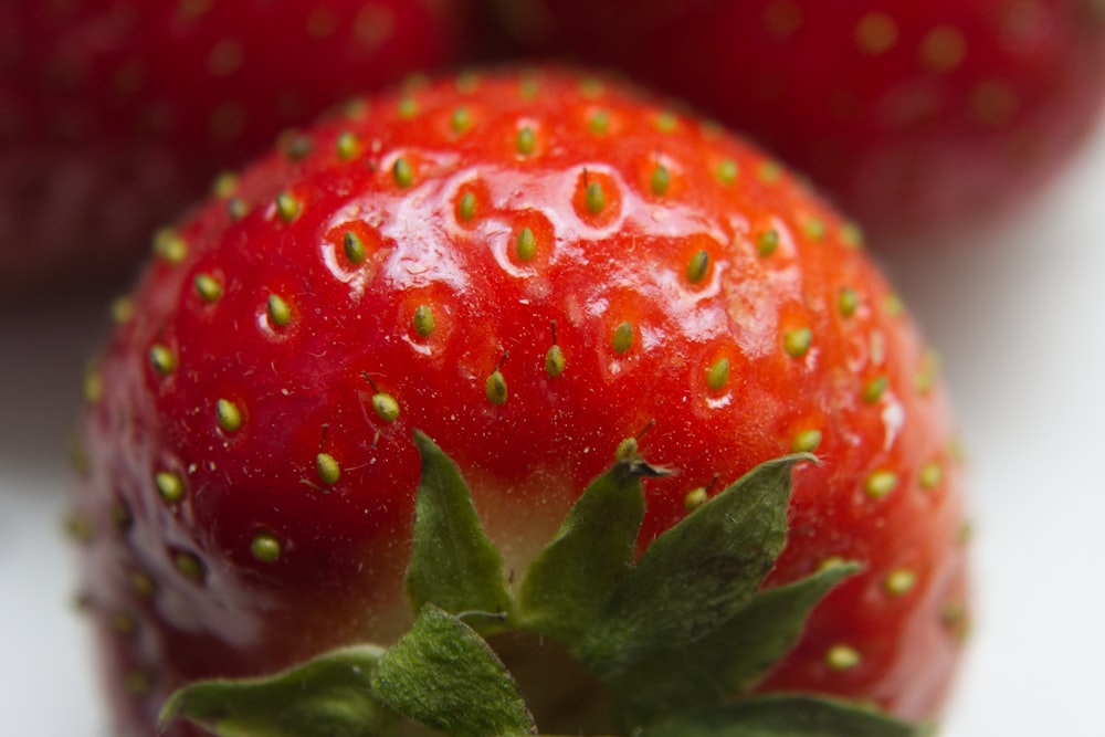 red strawberry fruit in close up photography